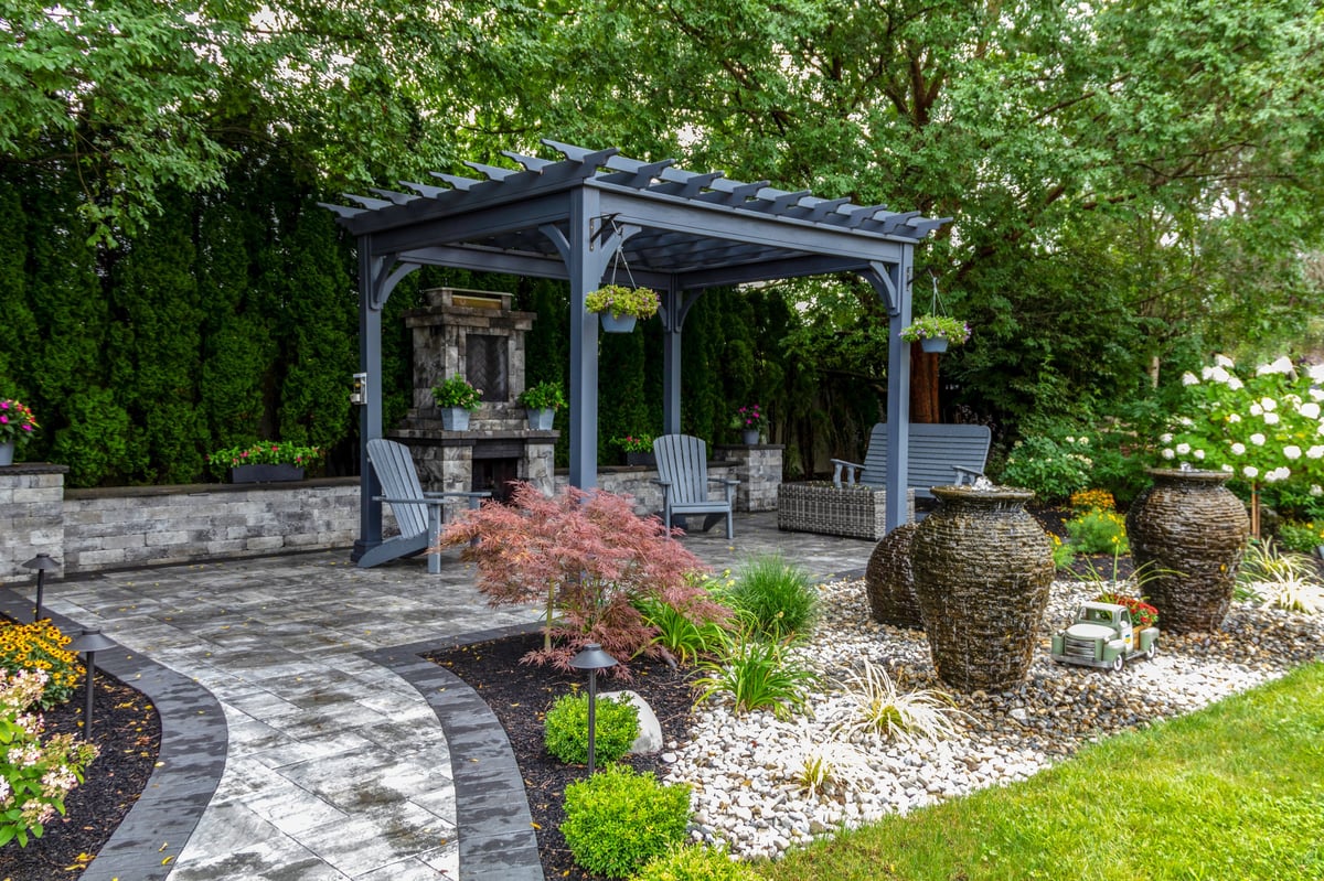 Large gray pergola with stone fireplace